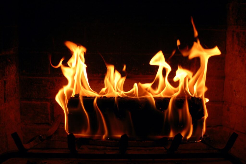 wood logs burning in a woodburner fireplace