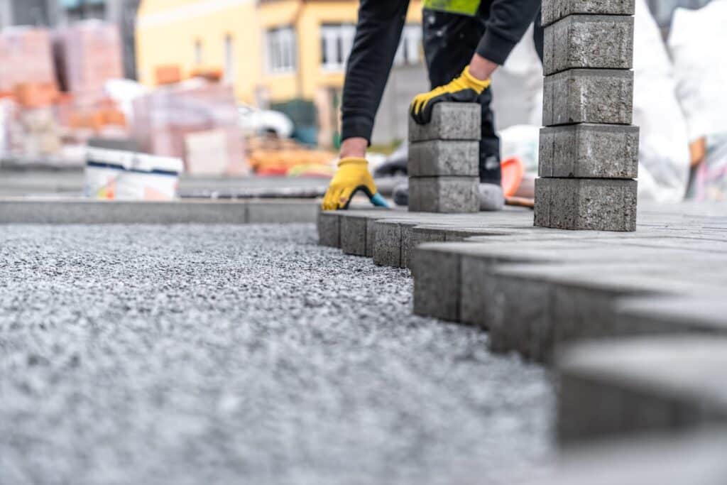 Landscapers installing concrete block paving