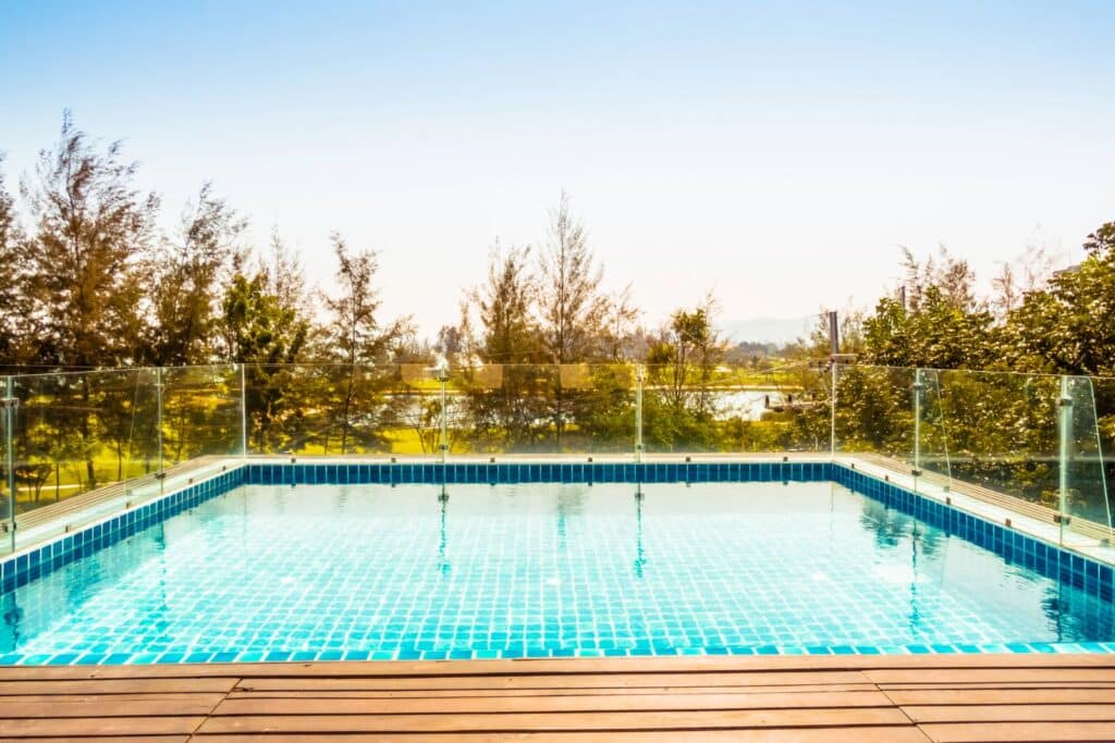 Swimming pool with glass pool fence