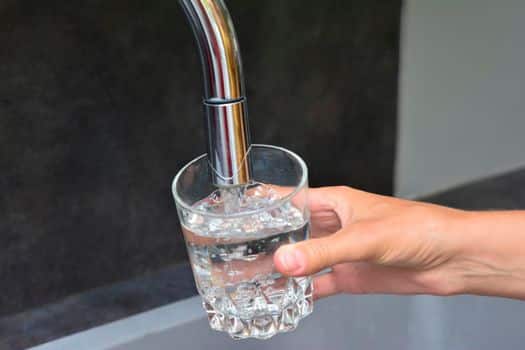 inspecting kitchen tap is working properly