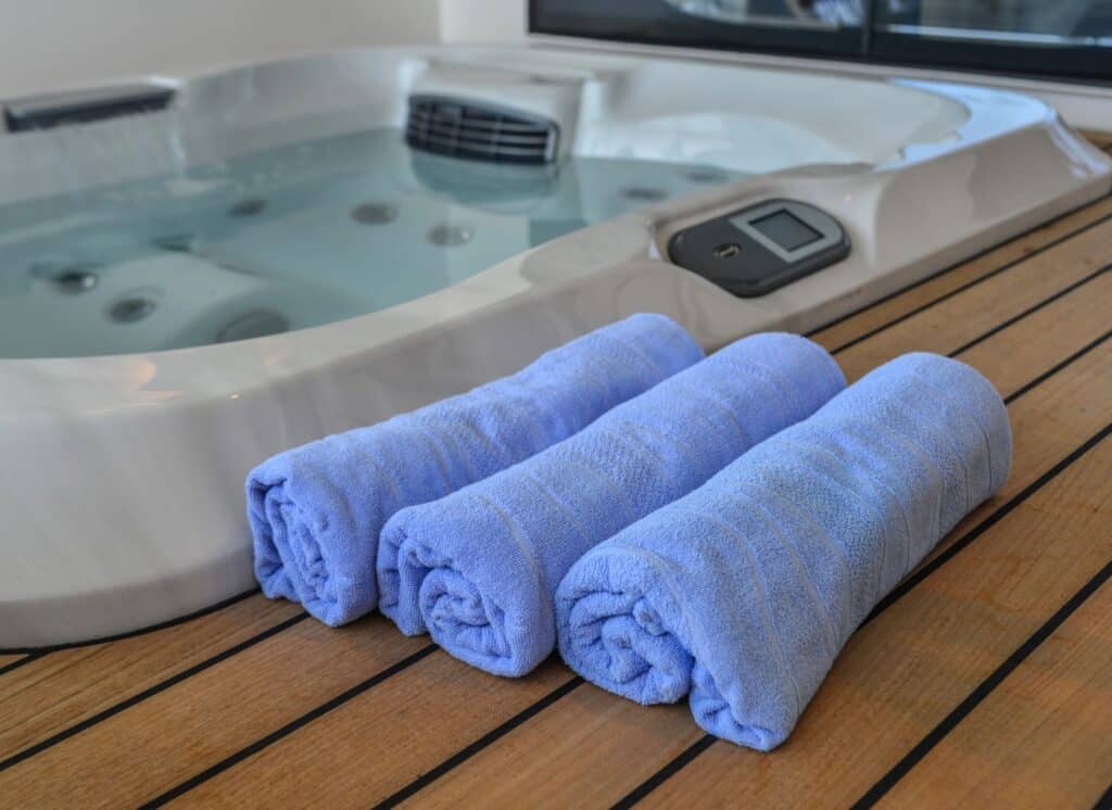 spa pool with wooden deck and towels